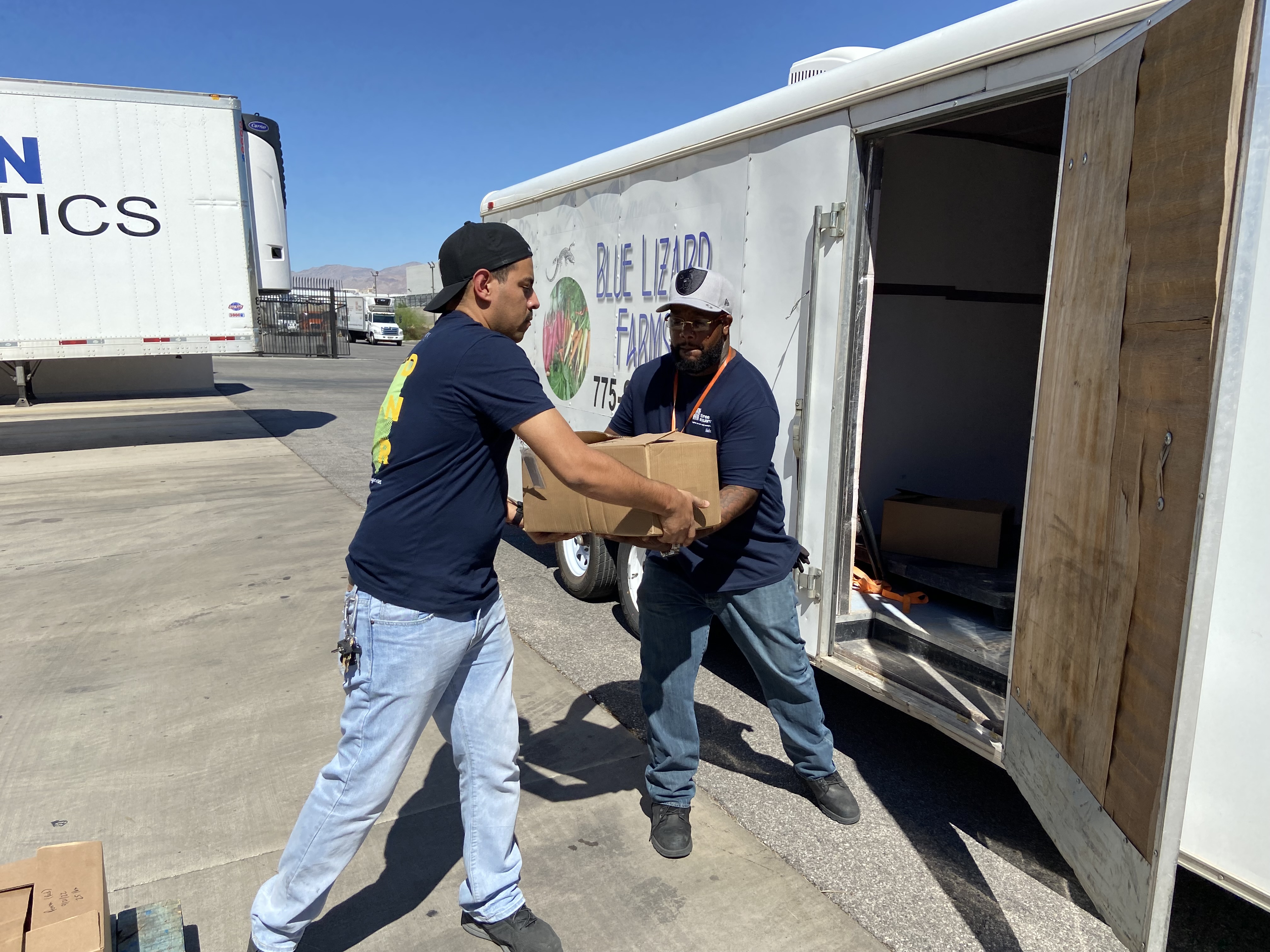 Boxes of tomatoes from Blue Lizard Farms are delivered and unloaded at Three Square Food Bank in Las Vegas, Nev. 