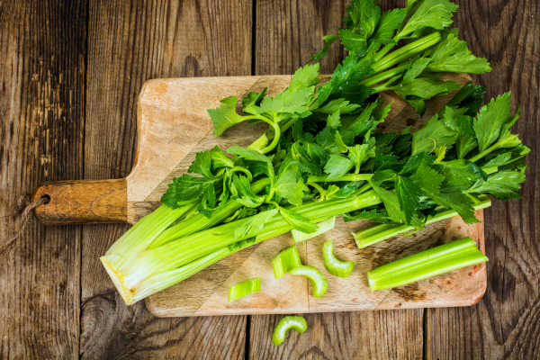Photo of celery stalk on cutting board.