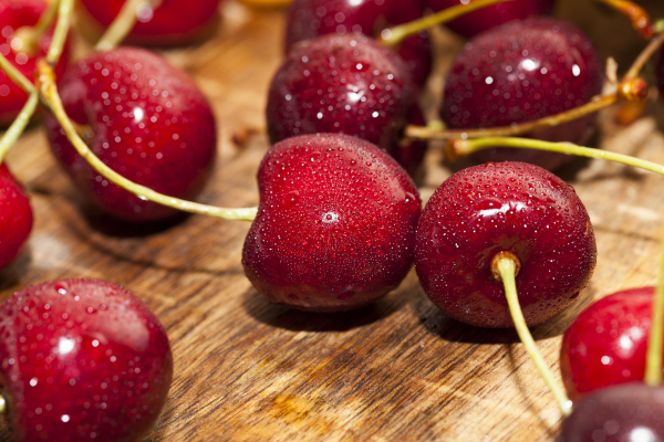 Photo of freshly washed cherries on a table. 