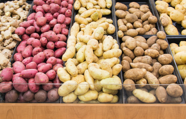 Photo of different potato varieties on display at market. 